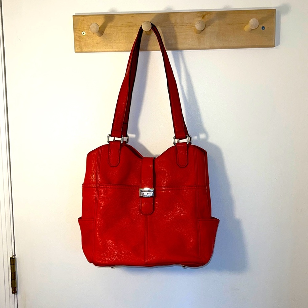 Tignanello red leather bag with pockets on front, back, both sides and inside.